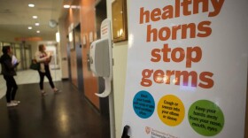 A sign in the University of Texas at Austin's Student Services Building shows information on how to prevent the spread of airborne illnesses. 