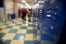 blue school hallway lockers and checkered tile in high school students in the background (down-sampled to increase sharpness)