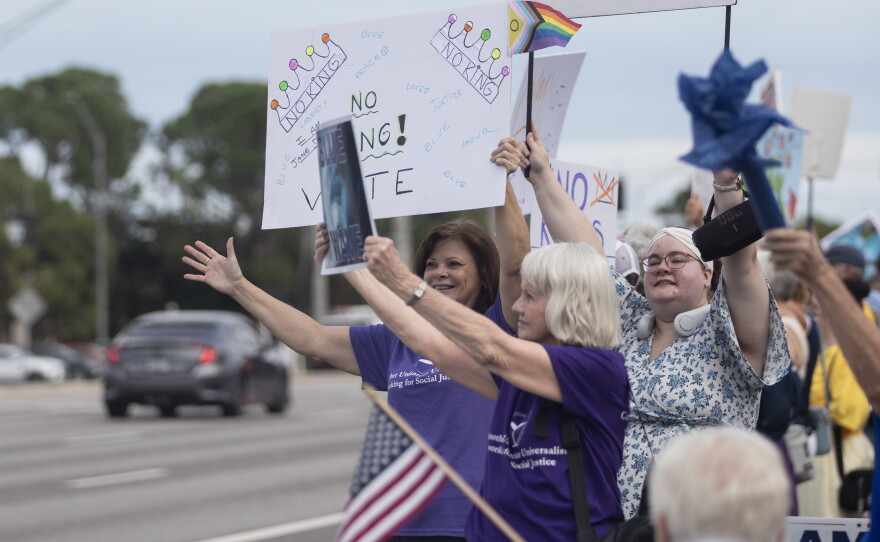 People gather along U.S. 41 in Fort Myers on Saturday morning, October 17, 2026, to advocate for change ahead of the mid-term elections. Organizers estimate about 1,000 people came out for the event.