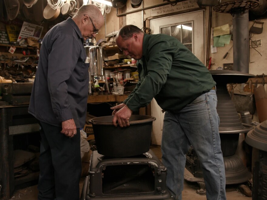 Emory Pineo (L) Owner/Operator of the Antique Stove Hospital repairing oven in workshop with son Brandon (R).