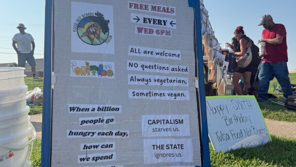 Signs displayed by Tulsa Food Not Bombs volunteers during one of their weekly "sharings."