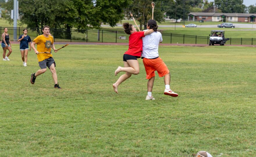 Players tackling each other in a game of stickball at Cherokee National Holiday