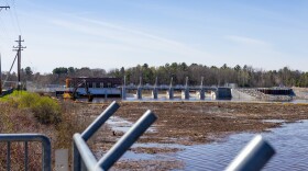 The Four Lakes Task Force works to remove debris brought up from the previously dried out lake bed as Sanford Lake is slowly refilled on Monday, April 20, 2026.