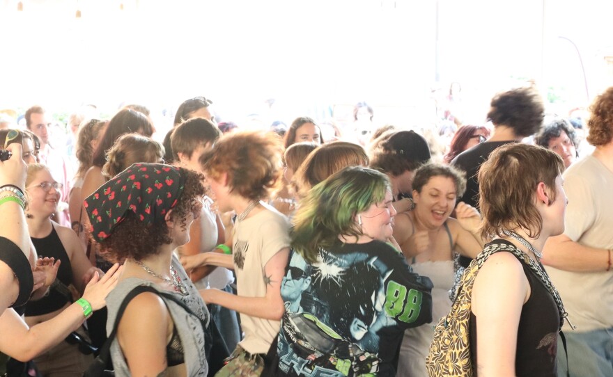 A crowd dances.