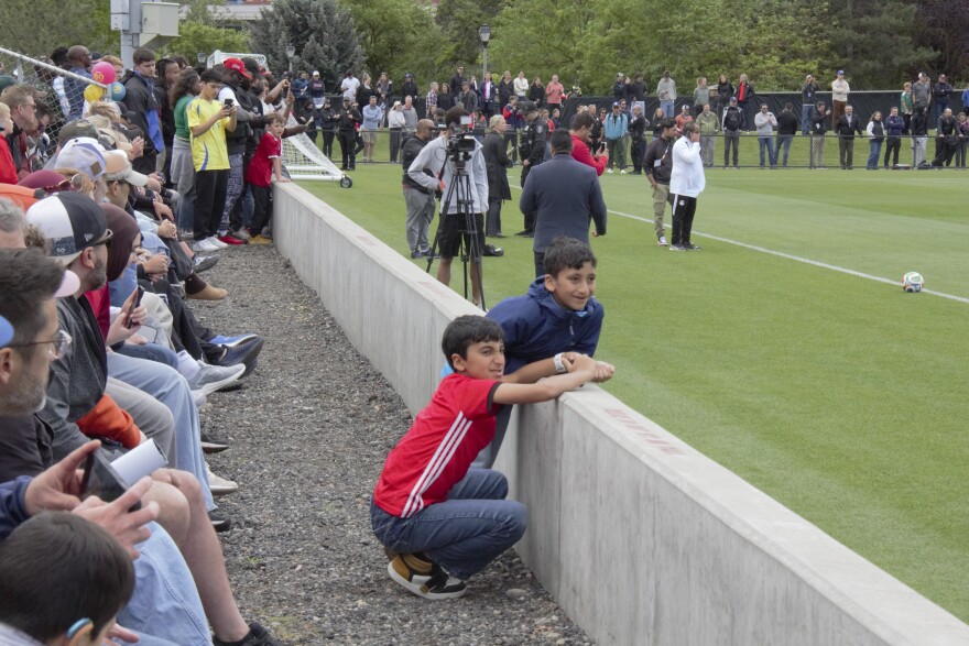Two young soccer fans take in Egypt's open training session at Gonzaga University's Luger Field on June 10.