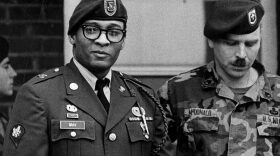 Spec. Ronald A. Gray, pictured leaving a Fort Bragg courtroom escorted by military police in April 1988. (Marcus Castro/The Fayetteville Observer/AP)