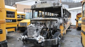 A burned-out Pike County school bus sits in the Pike County Schools transportation lot in Pikeville after catching fire early Thursday morning. School district officials believe the fire was intentionally set.