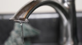 A trickle of water comes out of the faucet.