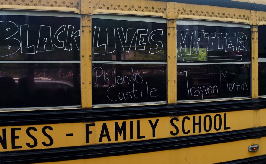 A school bus has "Black Lives Matter" written on it with the names Philando Castile and Trayvon Martin.