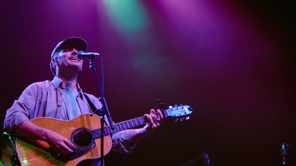 a man performing with an acoustic guitar