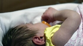 A week-old baby lies in a neonatal intensive care unit bay at the Norton Children's Hospital in Louisville, Ky. (Timothy D. Easley/AP)