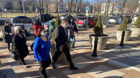 Lauren Knox, the wife of former state Democratic lawmaker Michael DiMassa, leaves the federal courthouse in New Haven with her mother and attorney. Knox, who now goes by Lauren DiMassa, pleaded guilty to a federal conspiracy charge on July 12, 2022.