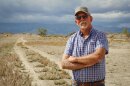 Carbon County farmer Kevin Cotner stands next to a bare field south of Price, Sept. 30, 2025. He’s one of around a dozen Utah farmers who are leaving some of their land unplanted and unirrigated this year as part of a state effort to leave more water for the Colorado River.