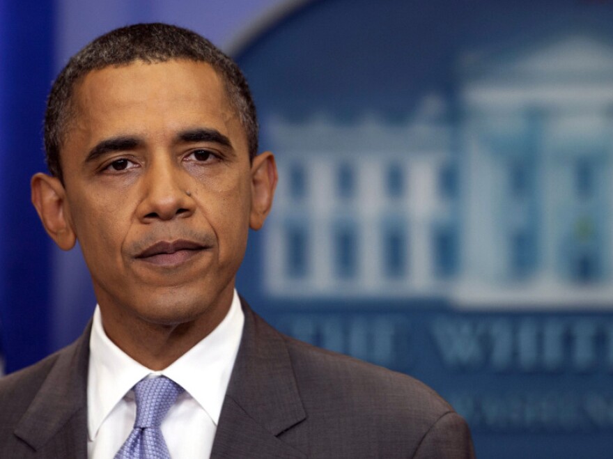 President Obama pauses as he speaks about the deal to raise the debt limit in the White House briefing room on Sunday.