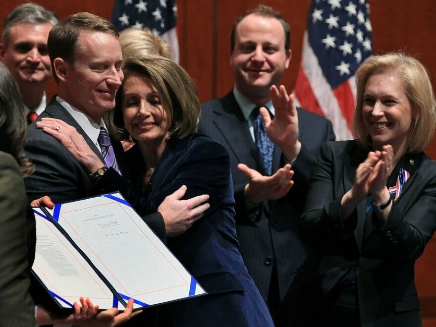 Tuesday: Former U.S. Air Force Major Michael D. Almy (L) hugs House Speaker Nancy Pelosi, D-CA, after she signed legislation repealing "don't ask, don't tell." It's now on the president's desk, awaiting his signature today.