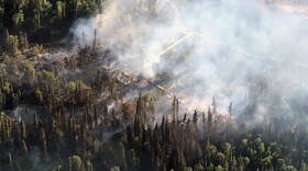A photo of the 8.5-acre Aniak River Fire taken during initial attack on Tuesday night after the Aniak River Lodge and multiple guest cabins were burned. (Alaska Division of Forestry)