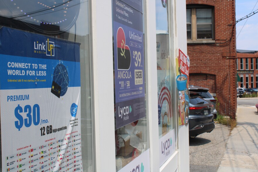 Signs in a shop window in Biddeford advertise international SIM cards on Wednesday, July 15, 2026, reflecting the growth in new immigrant communities from Central Africa, Latin America, the Middle East and elsewhere.