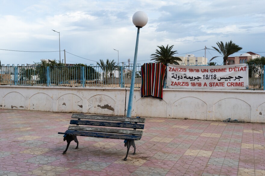 A sign in downtown Zarzis refers to the boat that sank in September with 18 Tunisians on board.