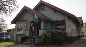 A customer walks into Eugene's House of Records on April 7, 2026. The business has called this converted house its home since 1973.