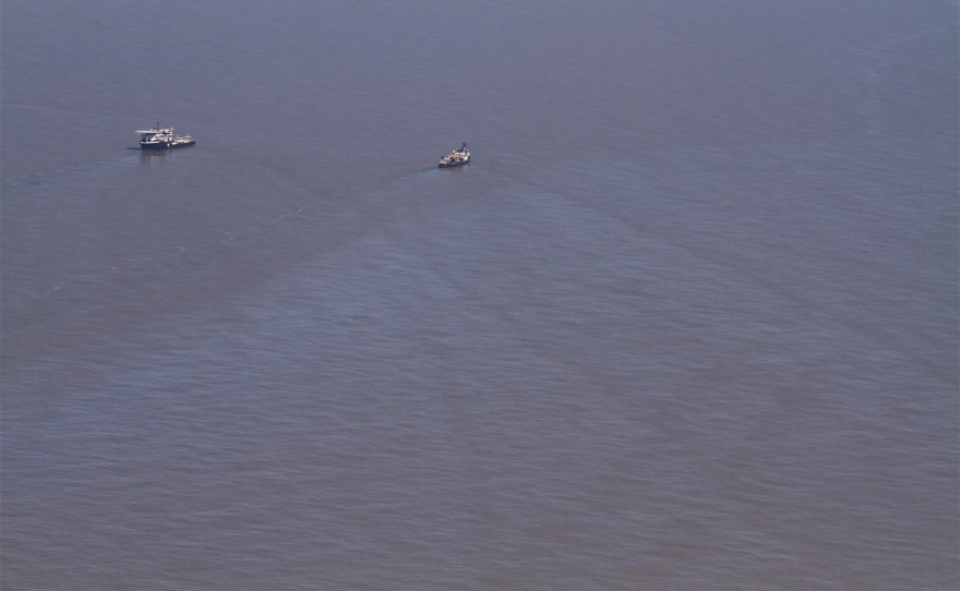 An oily sheen as seen from a plane in March 2019. An oil well owned by Phyllis Taylor was damaged in 2004 and has been leaking ever since. Taylor disagrees with the Coast Guard about how much oil has leaked since 2004.