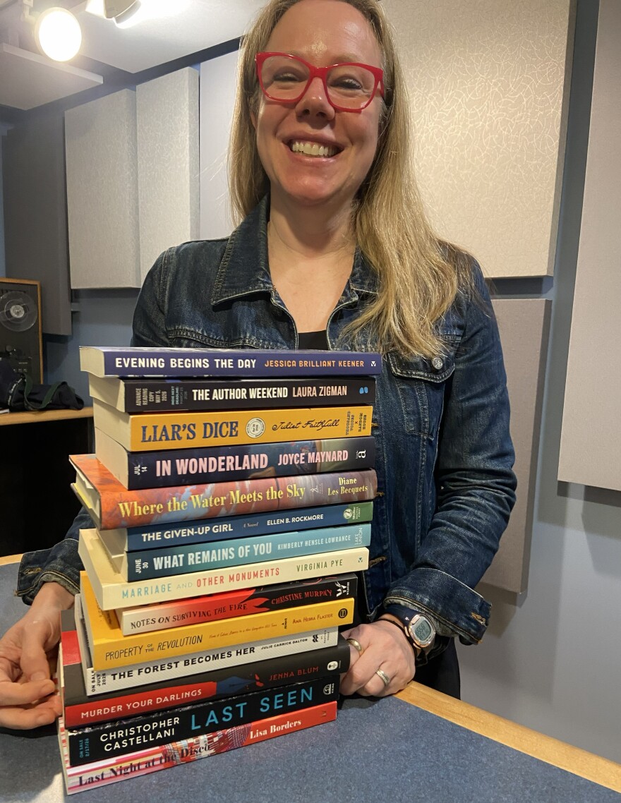 Rachel Barenbaum with a stack of books by New England authors.