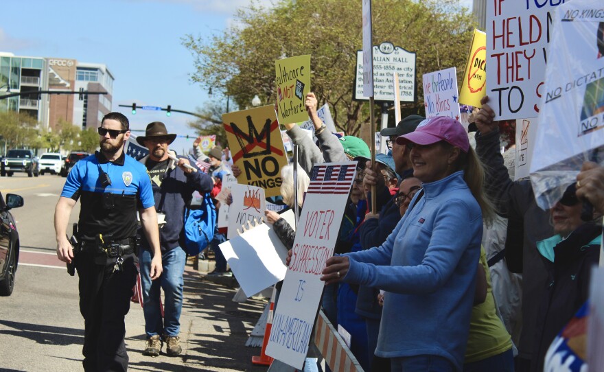 Protestors holding up signs on Princess Street during the No Kings protest.
