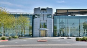 Gray building with large glass windows reads "AXON"