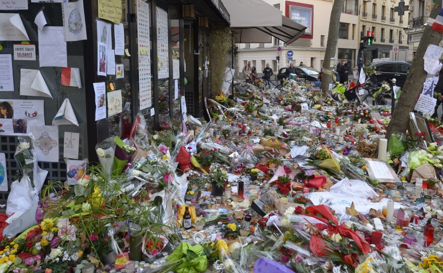 Copies of Ernest Hemingway's book <em>A Moveable Feast</em> are being left at spots in Paris where attackers set upon civilians last week. Here, the Cafe Belle Equipe is seen on rue de Charonne, where flowers and other mementos mark the site.