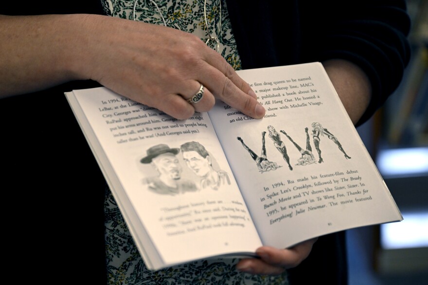 Kate Byroade, Library Director at the Cragin Memorial Library with the book “Who Is RuPaul?” open an illustration where VIVA is spelled out by the author in the older children’s section while speaking about how the selection policy at her library works, and how it comes into play with materials that may be viewed as controversial to some in Colchester, ϳԹ March 26th 2025.