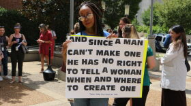 A protester holds a sign after Tennessee’s full abortion ban — called the Human Life Protection Act — took effect in 2022.
