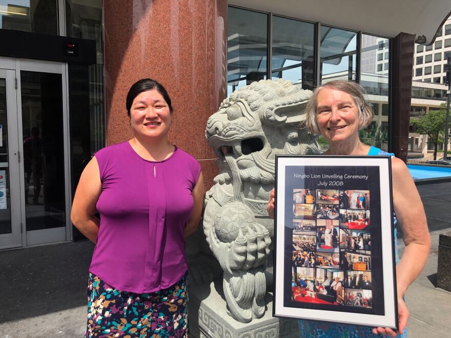 Question-asker, Nicole Reid (left) and Martha Brown (right), former deputy commissioner of the Milwaukee Department of City Development stand in front of one of the lion statues outside of the Zeidler building.