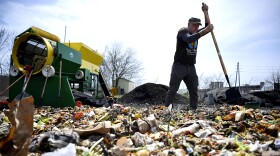 FILE: Domingo Medina chops food scraps that his workers hauled in to a lot where his business makes compost. Medina runs Peels & Wheels Composting, which uses bicycle trailers to pick up food scraps from subscribers around New Haven, Conn. The compost is then given to subscribers or donated to local community gardens. Medina says it’s important to get organic materials that will otherwise be burned or sent to a landfill out of the wastestream. “Organic residues are a resource, it’s not waste,” he said.