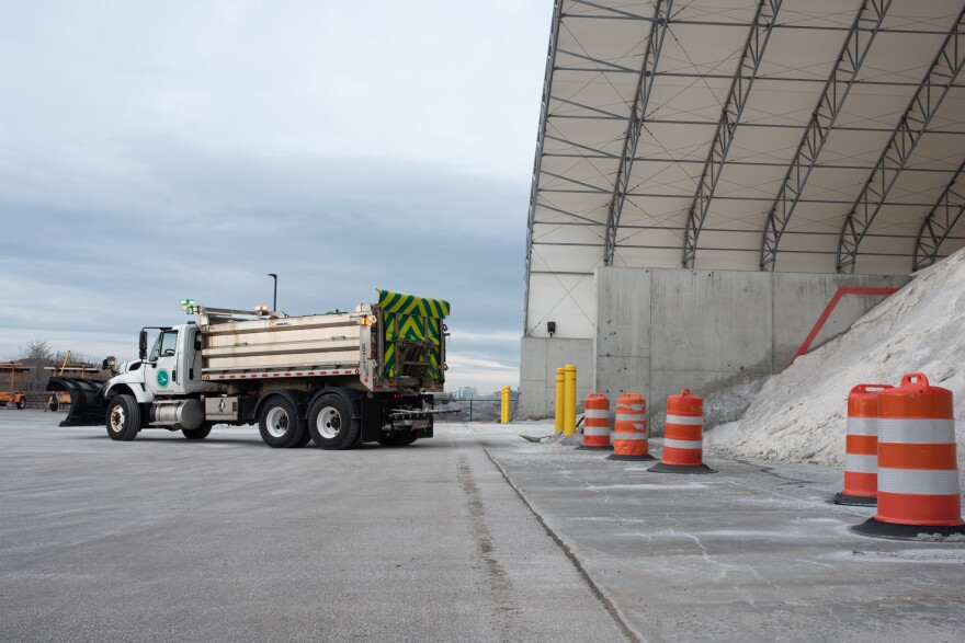 An ODOT truck parked beside a hanger full of road salt.