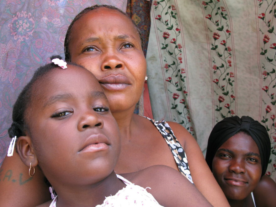 Marie Claudine Macena (with two of her daughters) lives with seven others in a shelter at the Petionville Club camp. Macena says her shelter floods every time it rains. The camp is among those the U.N. designated as being in urgent need of relocation before the heavy rains begin.