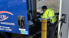 Truck driver Mohamed Jomni charges one of NFI's new electric trucks at a warehouse in Chesapeake on Thursday, Jan. 22, 2026.