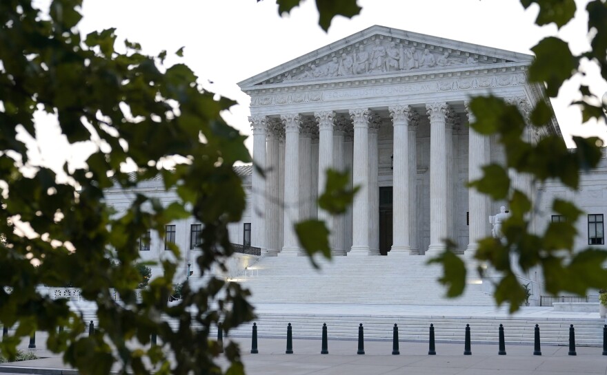 The sun rises behind the Supreme Court in Washington on Wednesday.