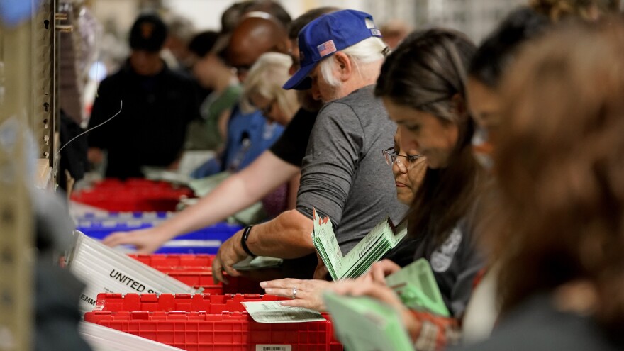 Election workers sort early ballots for signature verification prior to tabulation inside the Maricopa County Recorders Office, Tuesday, Nov. 8, 2022, in Phoenix.