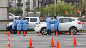 Staff work at a drive-through coronavirus testing site outside the American Airlines center in North Dallas in late March.