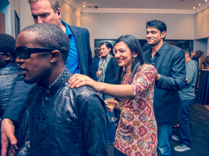 At the "Dinner in the Dark" restaurant that's just opened in Nairobi, a blind waiter leads guests to their table. The photo was taken during a training session — that's why the lights are on.