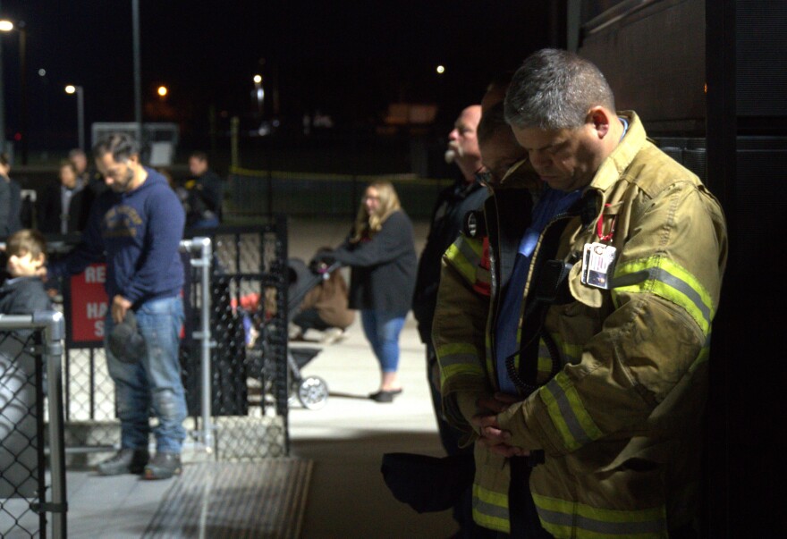 A firefighter bows his head in prayer as the memorial comes to a close.