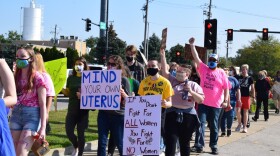 Locals marched on W. College Avenue on Saturday during the Women's rally #RedbirdsMarchOn advocating for women's reproductive rights.