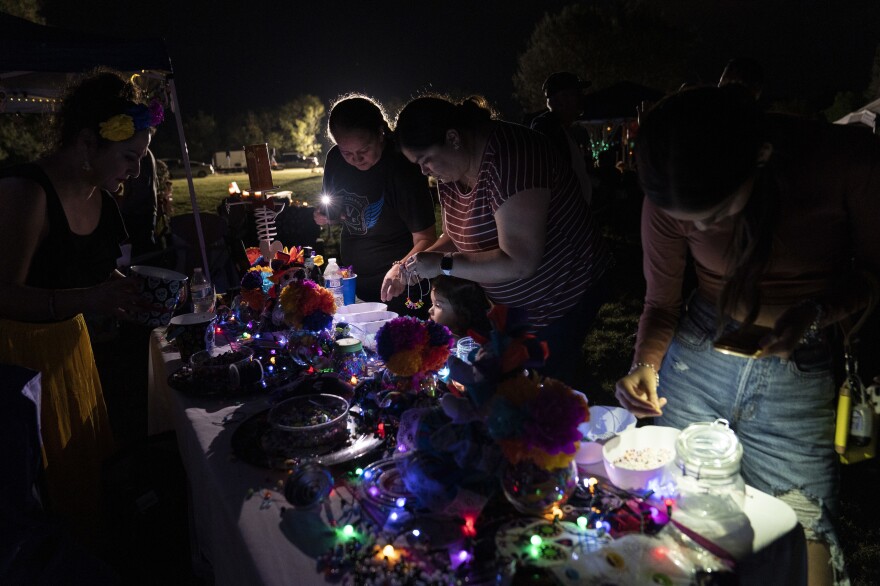 People make bracelets with beads, one of Jacklyn "Jackie" Jaylen Cázares' favorite activities, next to her grave.