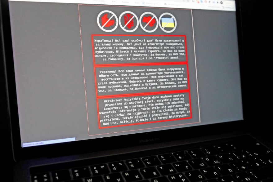 A laptop screen displays a warning message in Ukrainian, Russian and Polish, that appeared on the official website of the Ukrainian Foreign Ministry after a massive cyberattack, in this illustration taken January 14, 2022. REUTERS/Valentyn Ogirenko/Illustration