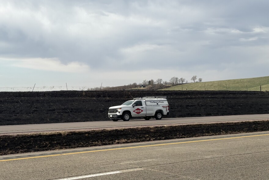 Traffic moves on U.S. Highway 20 near a burned out ditch area near Lawton, Iowa, on March 30, 2026. (Bret Hayworth, Siouxland Public Media News)