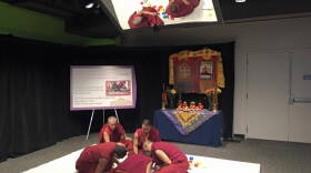 The monks of Tashi Kylil monastery are creating a peace sand mandala at the Children's Museum of Indianapolis.