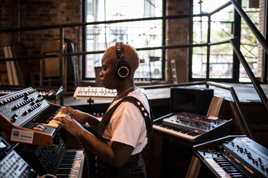 Tamko tries out keyboards at a music shop in Brooklyn. Tamko describes <em>Vagabon</em> as a flex: she plays many of the instruments you hear on it, and she learned the digital audio software Logic Pro so she could produce it almost entirely on her own.