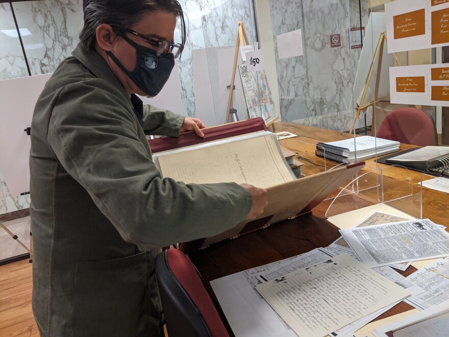 Bexar County Spanish Archivist David Carlson reads from the probate minutes in which Emelia Garza was adjudged insane.