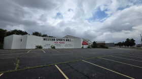 A large building with the words Western Sports Mall in front of a large parking lot.