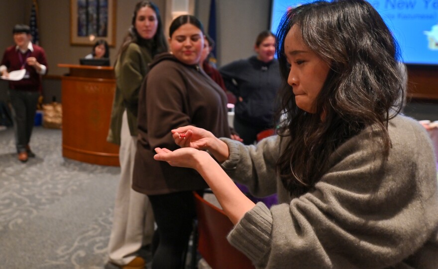 Xinyu Zhouv races to place an M&M onto a plate.