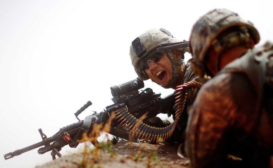 During an all-day gunfight, Spc. Jotiyar Saaty, with Bravo Company, 101st Airborne Division yells for more ammunition while trying to suppress heavy enemy fire.